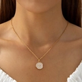Close-up of golden necklace with a round white starfish pendant on a white ruffled neck - Gold Starfish Pendant Necklace (30932)