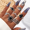Detail of vintage silver rings set with black gemstones in bohemian stacking style - Vintage Punk Skull Hand Sun Eye Style (27074-silver)