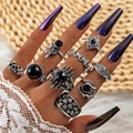 Close-up of vintage silver gothic ring set featuring skulls, black roses and dark gemstones - Vintage Gothic Skull Black Rose Style (27172-silver)