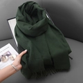 Dark green cashmere-like winter scarf with fringe tassels on a minimalist sofa - Dark Green
