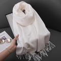 Soft white knit winter scarf featuring delicate fringe edges on a premium leather surface - Milk White
