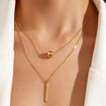 Detail of layered gold necklace with bead and vertical bar pendants on model - Gold Ball (30465-nek)