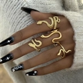 Set of four vintage gold snake-shaped wrap rings with textured scales on a female hand - Snake Shape Design (18866-A) / Four-Piece Set / Gold