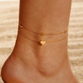 Detail of layered gold anklet with heart charm on sandy beach under sunlight - Double Layer Ball Chain with Heart Pendant (5323-ank-G-2)