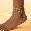 Bohemian gold layered anklet with snake charm and colorful beads on a sandy beach - Gold Colorful Bead Snake Style (27251-gold)
