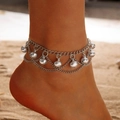 Close-up of bohemian layered silver anklet with bells on a person at a beach - Silver Bell Charms Style (30277-ank-S)