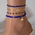 Four-piece bohemian anklet set featuring gold shell charms and dark blue beads - 4-Piece Anklet (21255-blue)