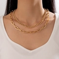 Double-layered gold chunky chain necklace with Cuban link design worn by a model - Layered Cuban Stackable Style (22740) / Gold Layered (22740)