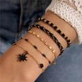 Detail of 5-piece gold and black layered bracelets set with star charm and beads - 5-Piece Bracelet (23411-A) / Black
