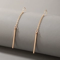 Minimalist gold bar drop earrings featuring polished geometric cylinders on a grey roll - Minimalist Bar Earrings / Gold (17991)
