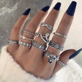 Detailed view of Gothic silver ring set featuring skull, moth and snake motifs on hand - 10-Piece Snake Skull Vintage Style (22858-silvery)
