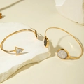 Detail of two gold open bangles with geometric marble insets on stone display - Minimalist Geometric Marble Pattern 2-Piece Set (31266-bra-G)