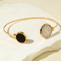 Detail of a gold open cuff bracelet with black and white marble stone circular accents - Black and White Round Marble Pattern Open Bangle (31265-bra-G)