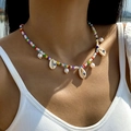 Detail of colorful beaded necklace featuring shell and pearl pendants on beach model - Colorful Seed Bead Evil Eye Style (27329-colour)