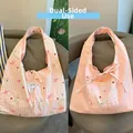 Close-up of reversible tote bag with pink stripes, bear print and drawstring closure - Pink Westie Dog Reversible Stripe