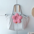 Detail der grauen Thermo-Lunchtasche mit rot-karierter Blume und Kordelzugverschluss - Grau