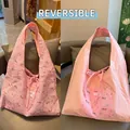 Close-up of pink double-sided tote bag with animal pattern and functional drawstring closure - Pink Spotted Dog Reversible Seersucker