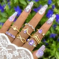 Detail of 8pcs bohemian gold ring set featuring purple gemstones and infinity symbols - Gold Butterfly And Purple Geometric Assortment (26672-gold)