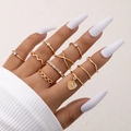 Nine-piece gold ring set featuring heart charms, stars, and crystals on a model hand - Gold (22664-gold)