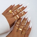 Detailed close-up of gold butterfly and heart ring set worn on fingers with pearl accents - Retro Bohemian Gold Style (22727-gold)