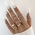 Detail of gold-tone multi-piece ring set featuring heart and spiral designs on hand - Gold (22726-gold)