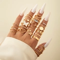 Close-up of gold butterfly and heart rings set with pearls and rhinestones on fingers - Gold (23494-G)