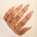 Detailed close-up of a 9-piece gold ring set featuring layered minimalist geometric designs - Chain Pendant Gold Style (28897-G)