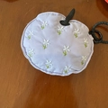 Detail of lavender apple-shaped fabric earphone pouch with floral embroidery - Purple Earphone Bag With All-over Embroidered Small Flowers