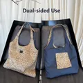 Detail of reversible tote bag showing leopard print canvas and dark blue denim sides - Reversible Khaki Leopard Bag