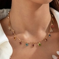 Detail of a gold necklace featuring colorful round and emerald-cut gemstone pendants - Multicolor Cut Gemstone Style (27830-nek-G-1)