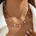 Detail of a vintage gold clavicle chain with pearls on a model wearing white - Elegant Artificial Pearl Style (27830-nek-G-2)