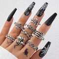 Macro detail of gothic silver rings set featuring skull and spider web punk designs - 9-Piece Skull Bone Spider Web Style (22888-silver)