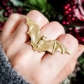 Gothic gold bat ring with detailed mesh wings on finger against nature background - Gothic Golden Bat Open Ring (24947-gold)