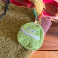 Detail of green quilted mini pouch with pink ring and colorful label on yellow bag - Fruit Green (Fruit Green Heart Quilted Pouch)