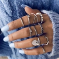 Set of ten silver rings with heart motifs and pearls worn on a light blue sweater background - Silver (22664-silver)
