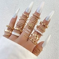 Bohemian gold ring set with cutout floral and pearl designs worn on long white nails - Gold (25304-gold)