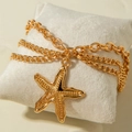 Three-layer gold starfish anklet with textured ocean pendant on a white cushion - Gold Textured Starfish Style (31705-ank-G-EP)