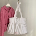 White canvas tote bag with ruched bottom design and pink have a nice day label - White