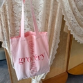 Detail of pink canvas tote bag with red grocery print and herb names in a soft setting - Light Pink