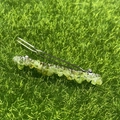Green crystal stone spring hair clip with silver base on natural grass background - Prehnite