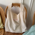 Chic cream white bubble texture tote bag with Have a Nice Day pink patch on a chair - Beige Pleated Style