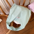 Mint green bubble textured tote bag with pink woven label on a wooden chair - Green Pleated Style