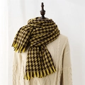 Yellow and brown geometric checkered knit scarf with tassels on a display mannequin - Yellow