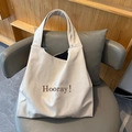 Minimalist beige soft leather tote bag with Hooray text print for women's daily commute - Off White