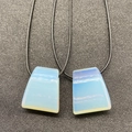 Trapezoid opal pendant on black braided rope showing translucent blue sheen and texture - 1 Piece / Synthetic Opal
