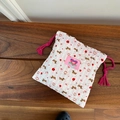Detail of pink striped seersucker drawstring pouch with apple and dog patterns - Apple Dog (5710392770699)
