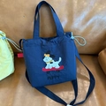 Dark blue canvas crossbody bag with cute puppy embroidery and drawstring closure - Navy Blue Skateboard With Drawstring Handle For Carrying Or Crossbody.