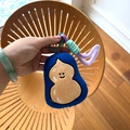 Close-up of cute plush doll keychain with embroidery details and braided rope - Yellow Gourd Stuffed Charm