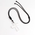 White agate cross pendant necklace with adjustable black braided cord on white background - White Crystal
