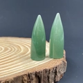 Polished green aventurine crystal bullet points on a rustic wood slice base - Green Aventurine